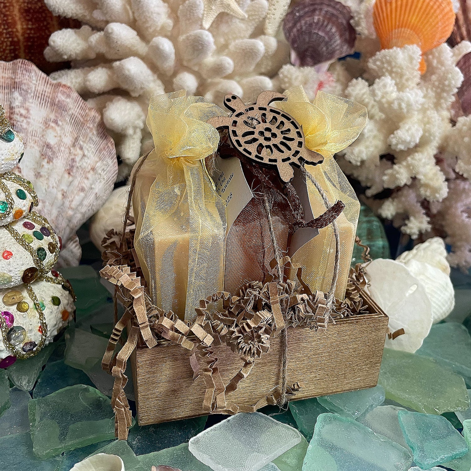 Simple Goat Milk Soap bar displayed on sea glass with seashells and coral in the background. Goat milk is high in both saturated and unsaturated fats, which create a creamy, foamy lather and provide deep moisture and nourishment for the skin.