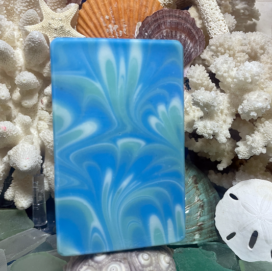 Handcrafted Seaside Melody bar soap with ocean-inspired swirls of bright blue, seafoam green, and white, creating a smooth coastal wave design
